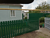 Забор из зеленого евроштакетника с односторонней зашивкой